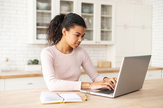 International woman using a laptop to search for information on the internet